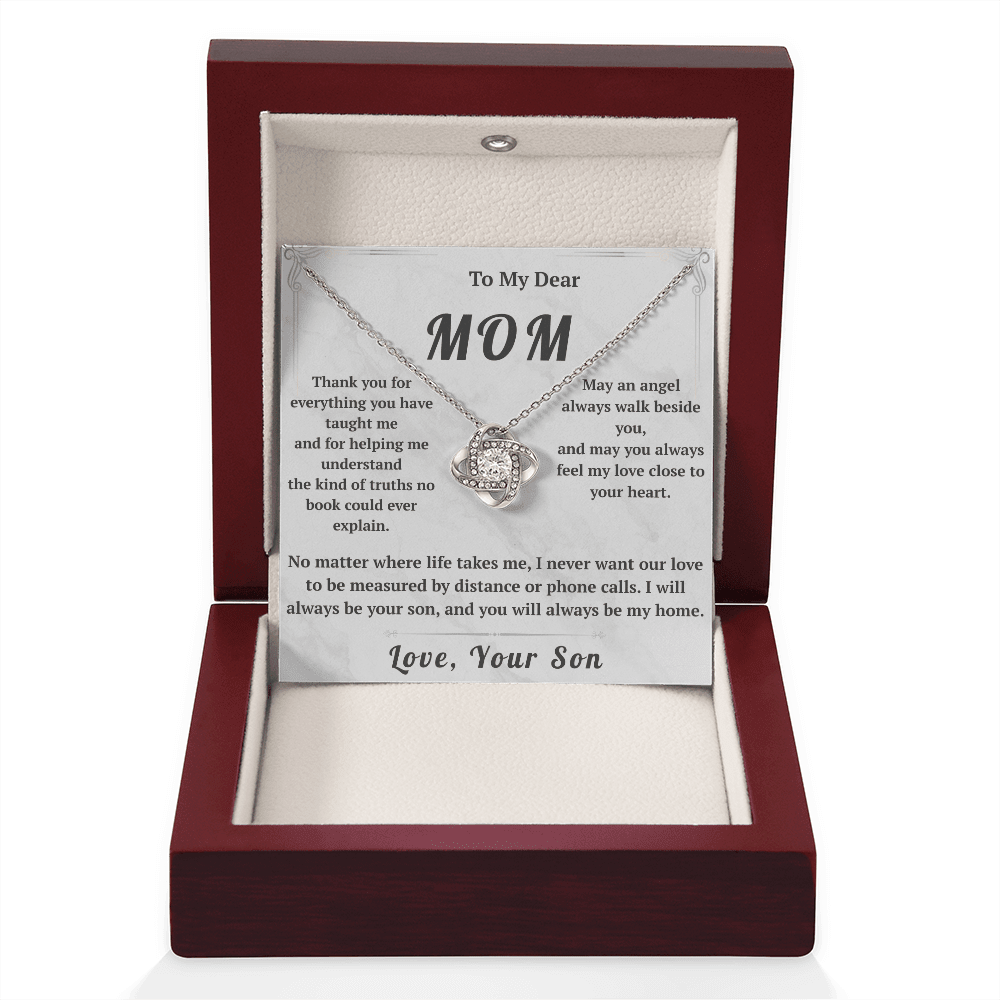 Necklace in a wooden box with a card for mom, on a white background