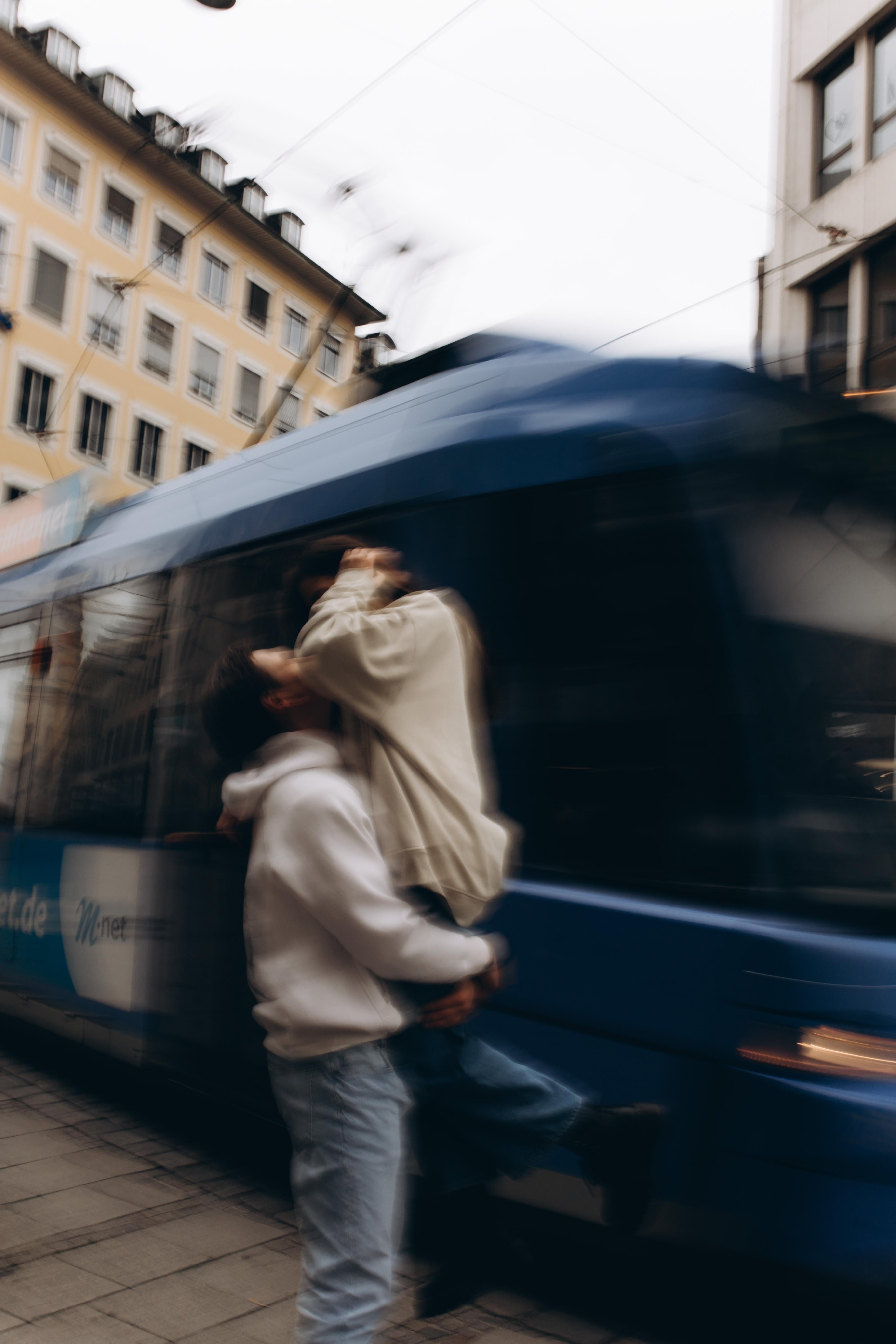 Person boarding a blue bus with blurred motion effect