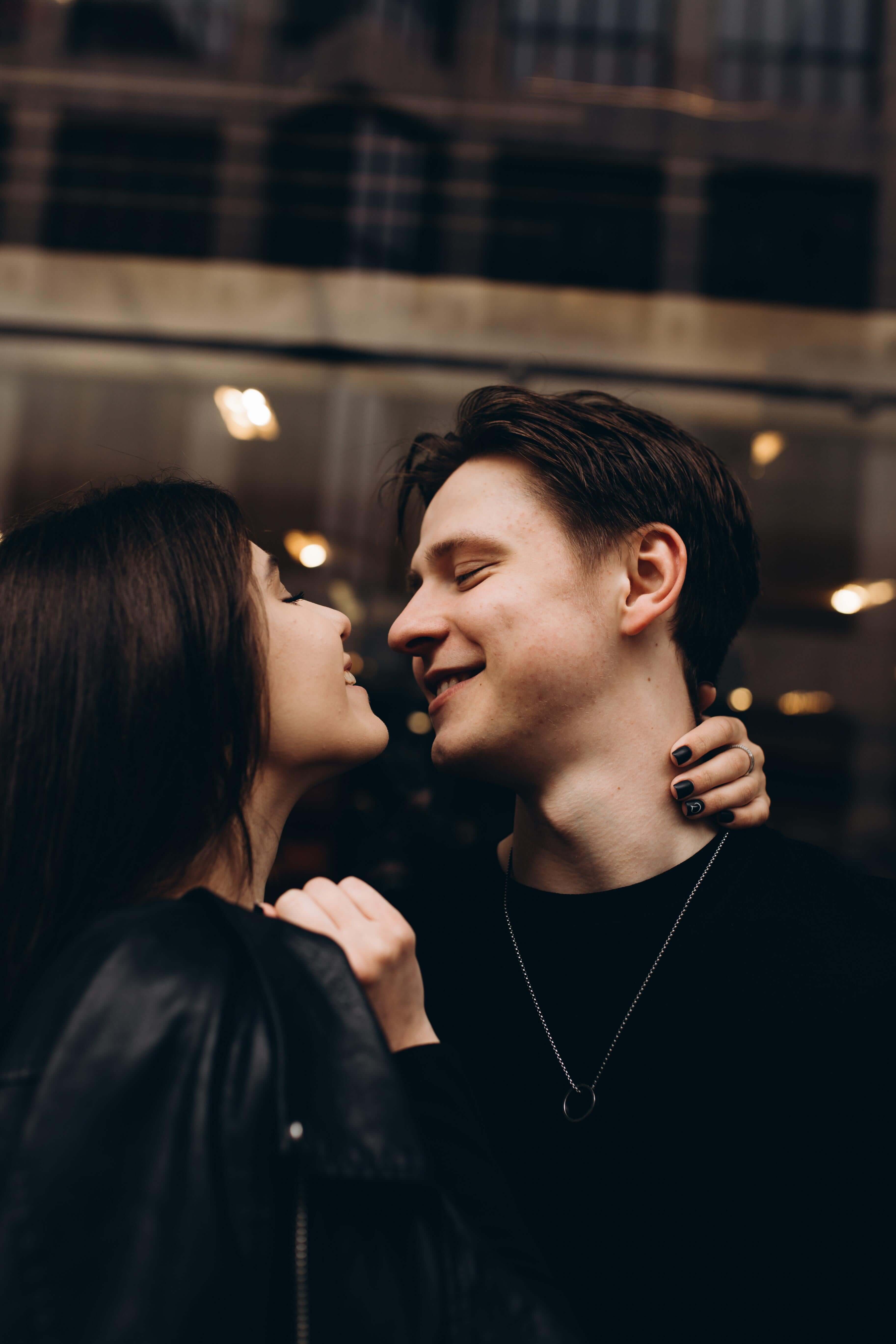 Two people embracing with a blurred indoor background