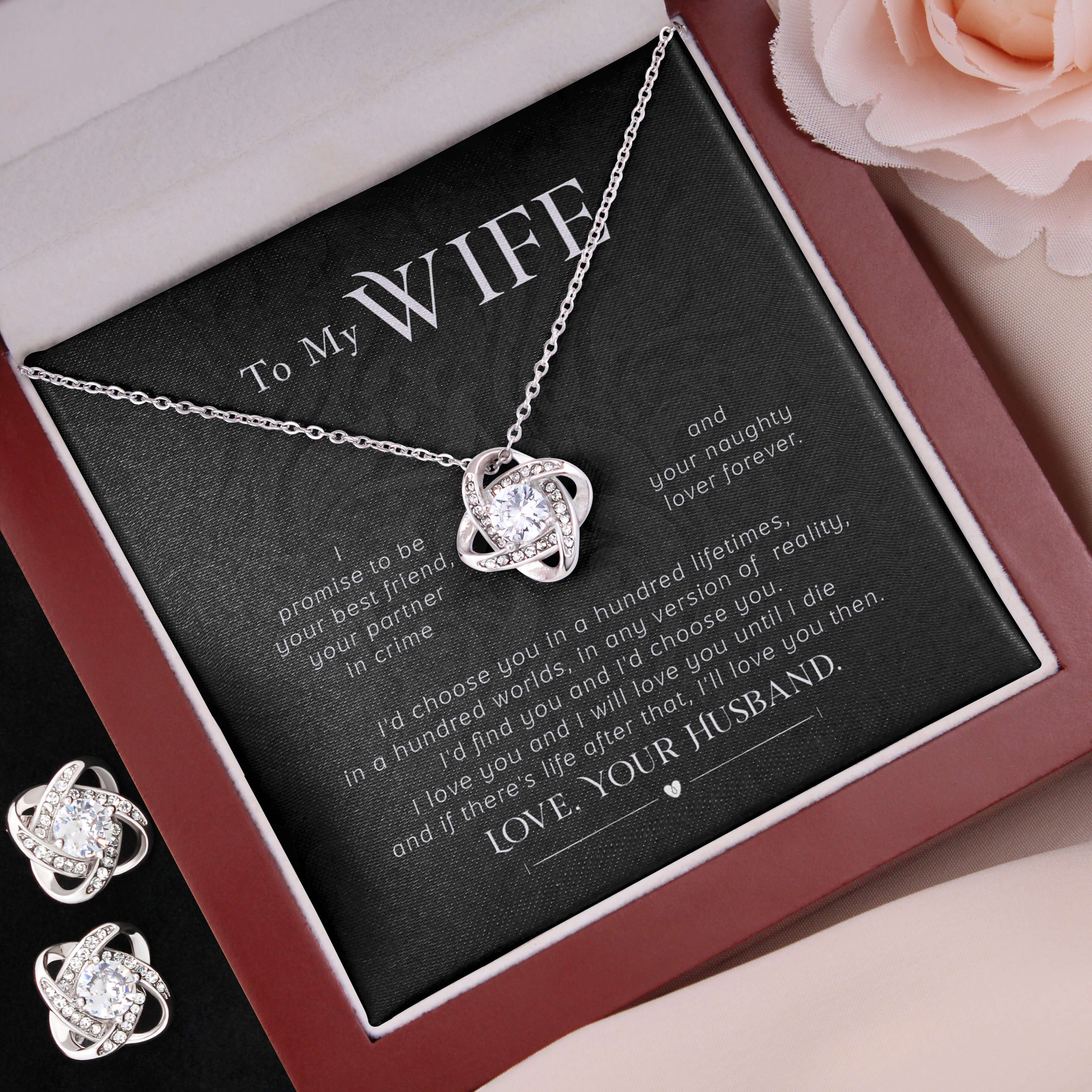Silver necklace and earrings set in a gift box with romantic message, on a soft pink background.