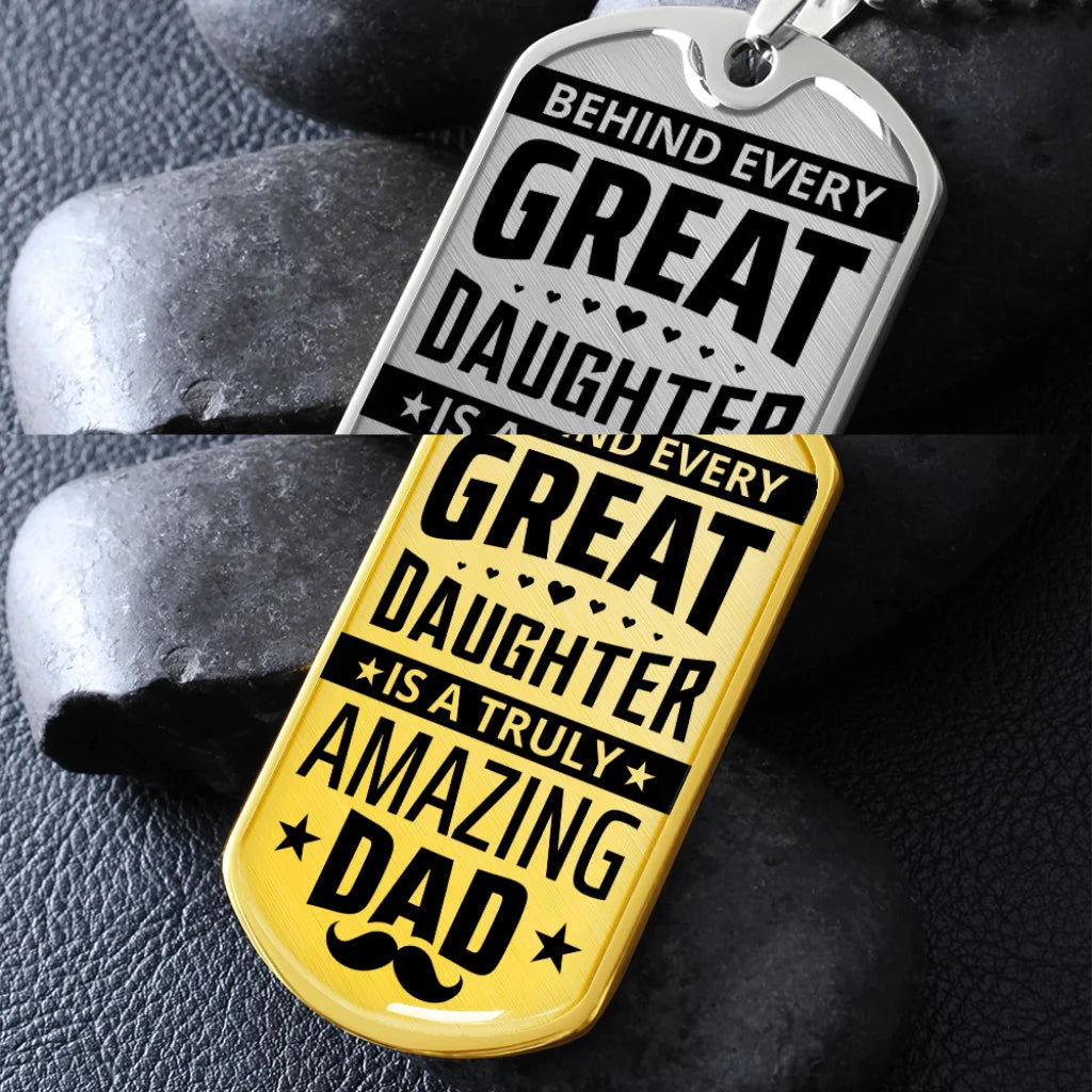 Two dog tags with motivational text on a dark stone background