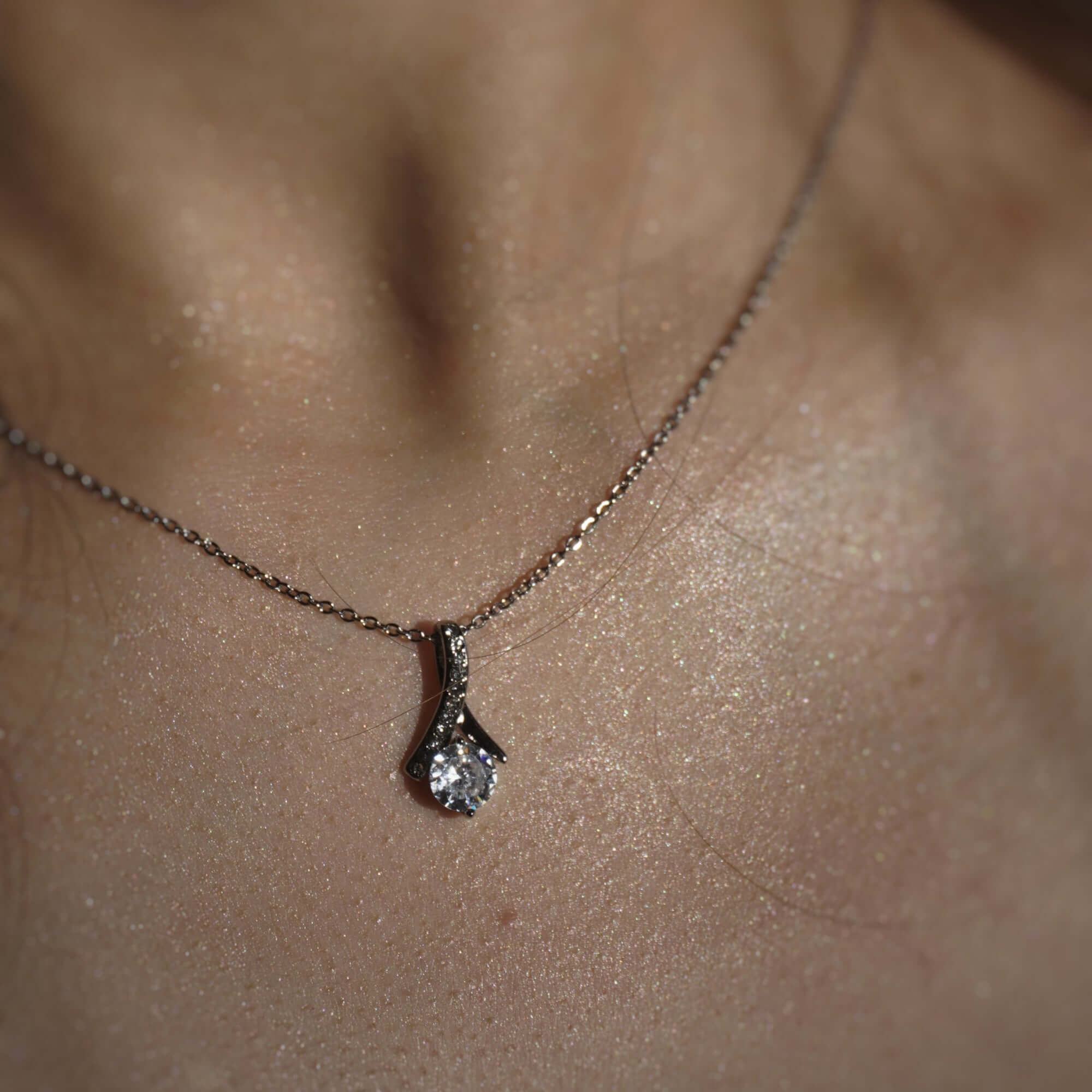 Necklace with a diamond pendant on a person's neck