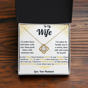Necklace with sentimental message card for wife on a wooden surface