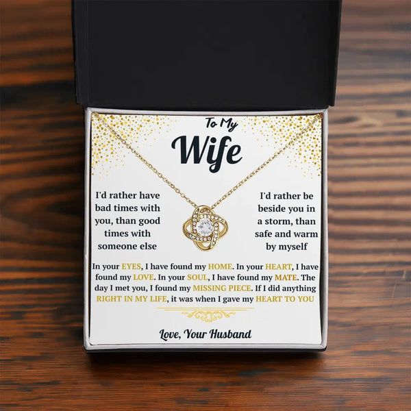 Necklace with sentimental message card for wife on a wooden surface