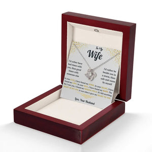 Necklace with a sentimental card in a wooden box on a white background