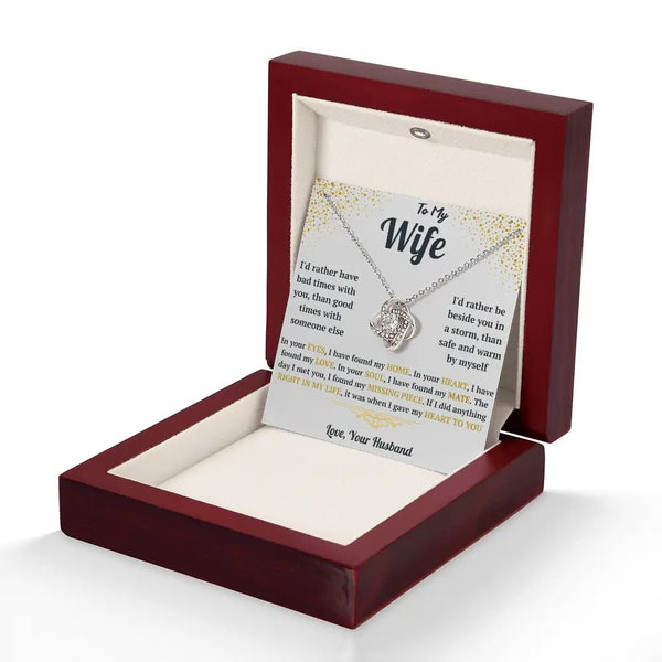Necklace with a sentimental card in a wooden box on a white background