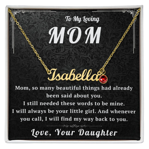 Gold necklace with a red heart pendant on a decorative card for mom