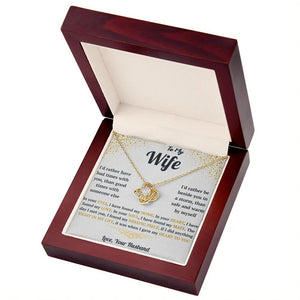 Gold necklace in a wooden box with a sentimental message card for 'Wife' on a white background