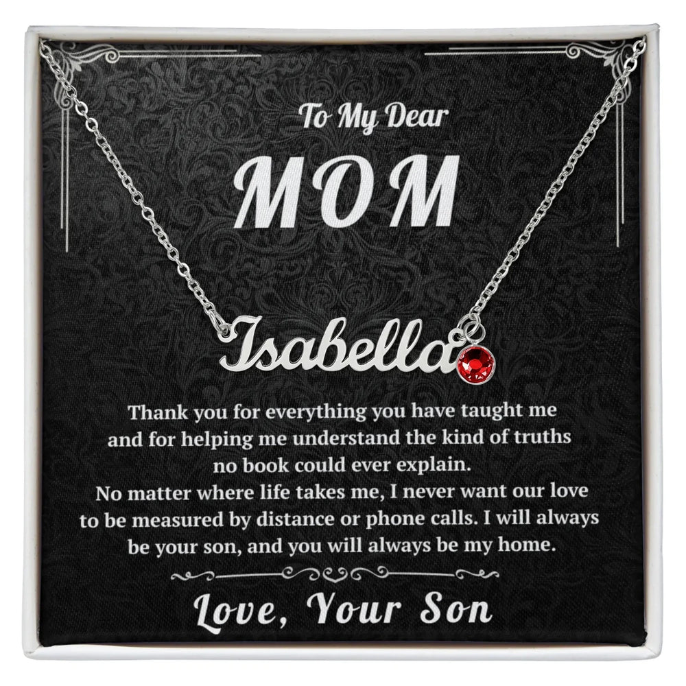 Necklace with a red heart pendant on a black card with personalized text for a mother.