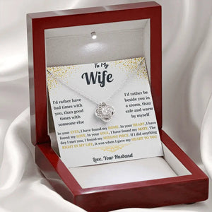 Necklace with a sentimental card in a wooden box on a white background